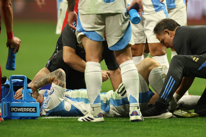Argentina s forward Lionel Messi (bottom) gestures in pain and is helped by assistant during the Copa America USA 2024,