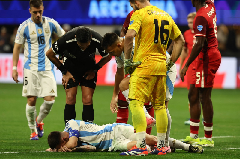 Argentina s forward Lionel Messi (bottom) gestures in pain during the Copa America USA 2024, group A, groupe stage match