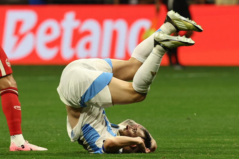 Argentina s forward Lionel Messi C falls on the field during the Copa America USA 2024, group A, group stage match betwe