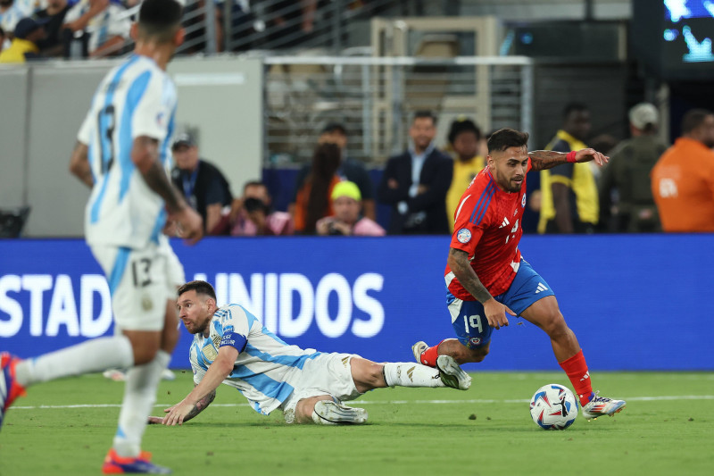 Chile s forward Marcos Bolados (R) controls the ball past Argentina s forward Lionel Messi during the Copa America USA 2