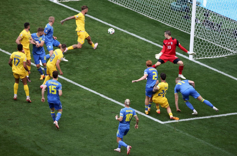 MUNICH, GERMANY - JUNE 17: Denis Dragus of Romania scores the goal 3:0 Andriy Lunin of Ukraine during the UEFA EURO 2024 group stage match between Romania and Ukraine at Munich Football Arena on June 17, 2024 in Munich, Germany. © diebilderwelt / Alamy L