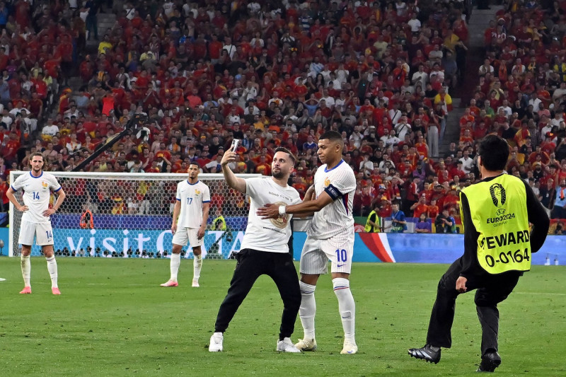 090724 A pitch invader tries to take a selfie with Kylian Mbappe of France during the UEFA EURO, EM, Europ