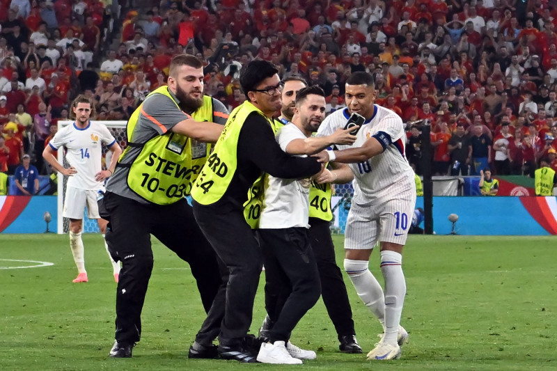 090724 A pitch invader tries to take a selfie with Kylian Mbappe of France during the UEFA EURO, EM, Europ