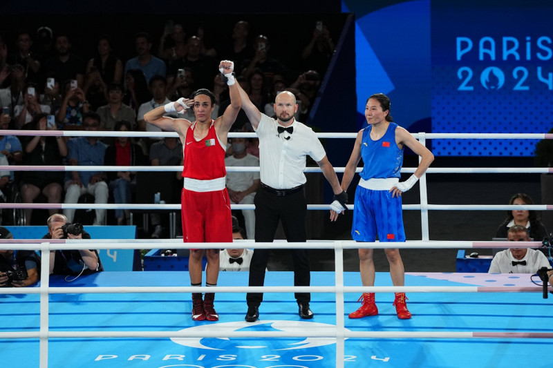 PARIS, FRANCE - AUGUST 09: Imane Khelif (red) of Team Algeria is announced the winner after defeating Yang Liu of Team C