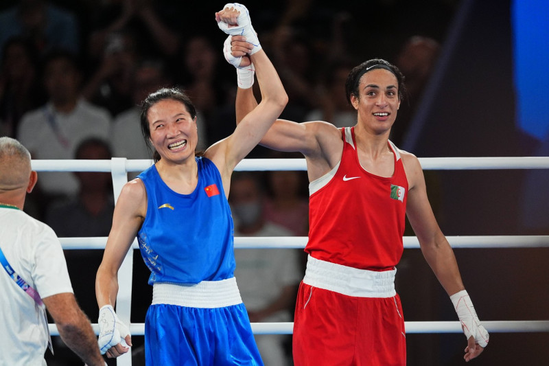 PARIS, FRANCE - AUGUST 09: Yang Liu (blue) of Team China and Imane Khelif of Team Algeria react after the Boxing - Women