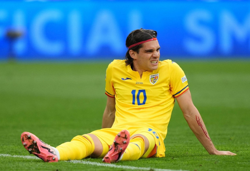 Romania's Ianis Hagi with an injured arm during the UEFA Euro 2024, round of 16 match at the Munich Football Arena in Munich, Germany. Picture date: Tuesday July 2, 2024.