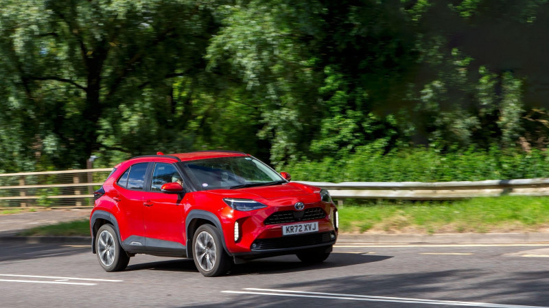 Milton Keynes,UK - June 22nd 2024: 2022 red Toyota Yaris cross excel hybrid electric car driving on a British country road