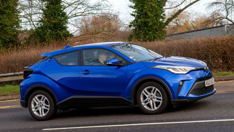 Milton Keynes, UK - Dec 28th 2023: 2022 blue Toyota C-HR hybrid electric car driving on a British road