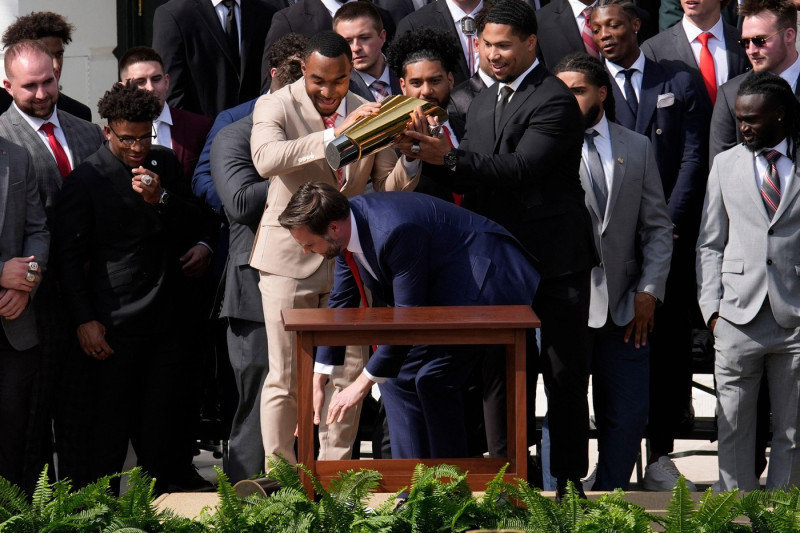 US Vice President JD Vance drops a base of the trophy as President Donald Trump welcomes 2025 College Football National Champions – The Ohio State University, on the South Lawn at the White House in Washington on April 14, 2025. Photo by Yuri Gripas/ABACA