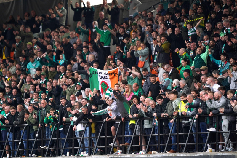 Celtic fans in the stands celebrate victory in the William Hill Premiership following the William Hill Premiership match at Tannadice Park, Dundee. Picture date: Saturday April 26, 2025.