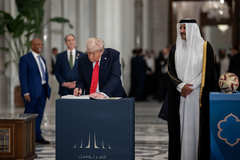 President Donald Trump, Amir of Qatar Sheikh Tamin bin Hamad Al Thani, and FIFA President Gianni Infantino take part in a signing ceremony after an official State Dinner at Lusail Palace in Doha, Qatar, Wednesday, May 14, 2025. (Official White House Photo