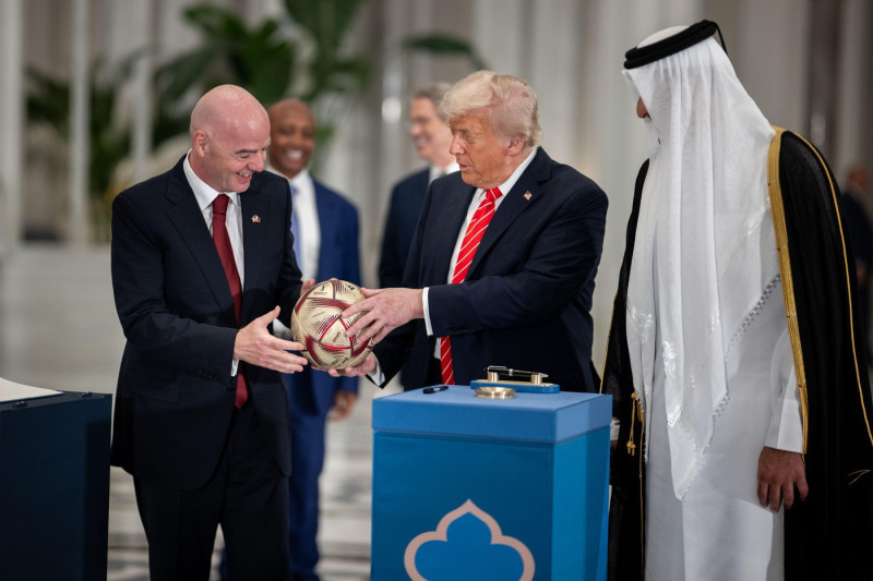 President Donald Trump, Amir of Qatar Sheikh Tamin bin Hamad Al Thani, and FIFA President Gianni Infantino take part in a signing ceremony after an official State Dinner at Lusail Palace in Doha, Qatar, Wednesday, May 14, 2025. (Official White House Photo