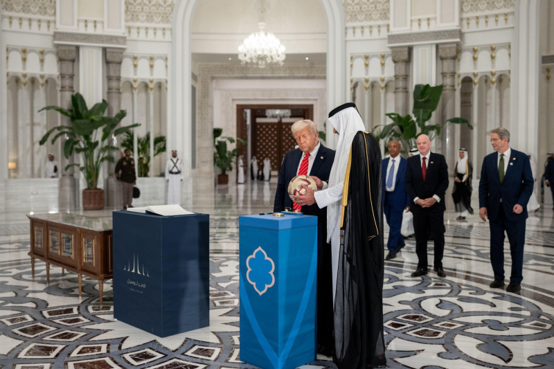 President Donald Trump, Amir of Qatar Sheikh Tamin bin Hamad Al Thani, and FIFA President Gianni Infantino take part in a signing ceremony after an official State Dinner at Lusail Palace in Doha, Qatar, Wednesday, May 14, 2025. (Official White House Photo
