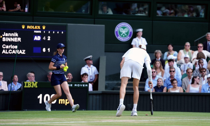 Jannik Sinner flicks a champagne cork off court during his Gentlemen's Singles Final against Carlos Alcaraz on day fourteen of the 2025 Wimbledon Championships at the All England Lawn Tennis and Croquet Club, London. Picture date: Sunday July 13, 2025.