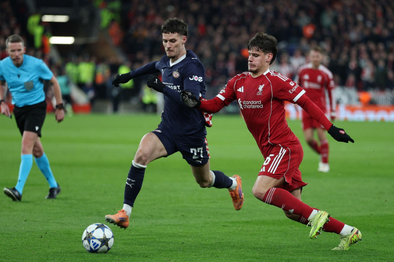 Liverpool, England, 26th November 2025. Dennis Man of PSV Eindhoven and Milos Kerkez of Liverpool challenge for the ball during the Liverpool vs PSV Eindhoven UEFA Champions League match at Anfield, Liverpool. Picture credit should read: James Baylis / Sp