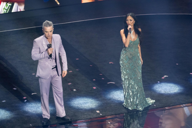 Robbie Williams and Nicole Scherzinger perform on stage during the 2026 FIFA World Cup draw at the John F. Kennedy Center for the Performing Arts in Washington, DC on December 5, 2025
