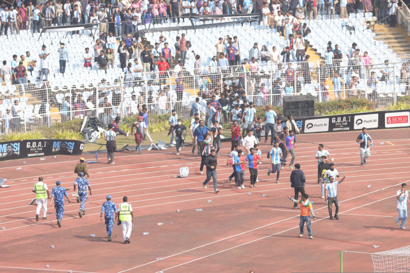 Spectator breaks the fence and enters Field Of Play during a riot during Lionel Messi G.O.A.T tour 2025 in Kolkata City Of Joy at Vivekananda Yuba Bharati Krirangan(VYBK) Stadium, Kolkata, West Bengal, India 13th December 2025 Photo by Shubhajit Roy Karm