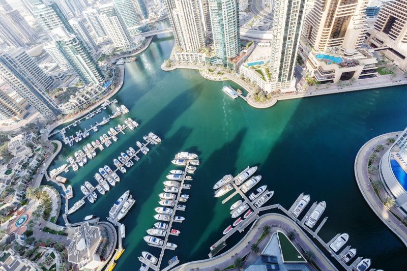 Dubai Marina and Harbour luxury wealth vacation with boats yacht from above