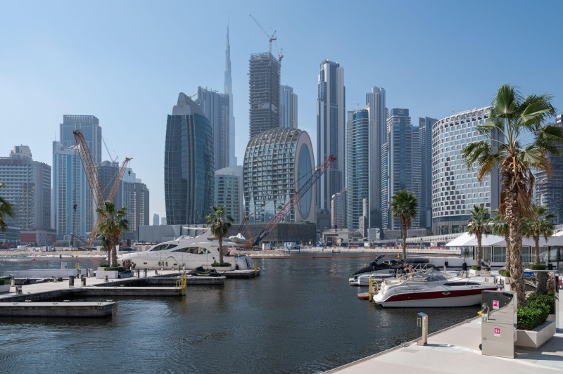 18.03.2025, Dubai, United Arab Emirates, Asia - Motor yachts along Al Jadaf Dubai Canal with the modern city skyline in the backdrop.