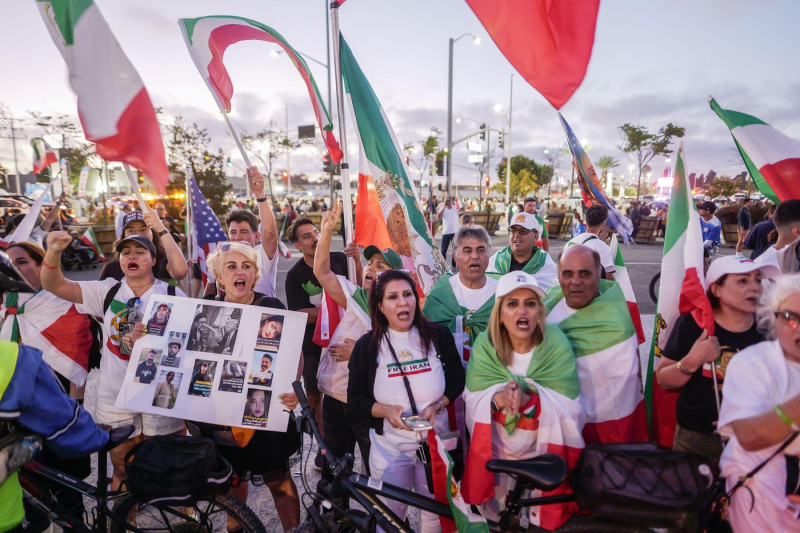 Demonstrators plan to wear T-shirts featuring the Lion and Sun emblem and wave the flag used prior to the 1979 Islamic Revolution, protesting the deadly crackdown on dissent in Tehran. Iranian-Americans are divided over Iran's participation in the World C