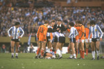 Gonella, the referee of Italy looks at his watch as an Argentinan player lies injured on the ground