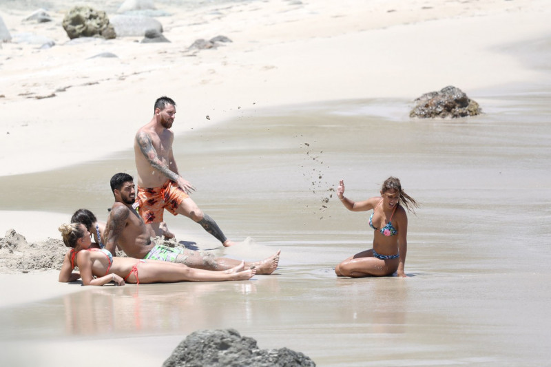 EXCLUSIVE: **PREMIUM EXCLUSIVE RATES APPLY** Soccer superstar Lionel Messi celebrates his honeymoon... by throwing sand at his hot new wife!