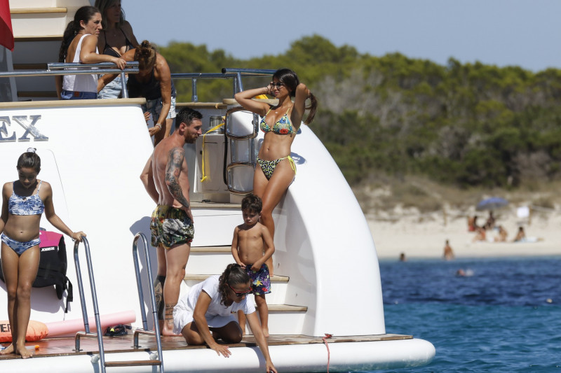 Soccer players Lionel Messi and Luis Suarez together with their wife and kids enjoy a boat day
