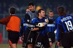 Buruk Okan of Inter Milan is restrained by team-mates after he was sent off