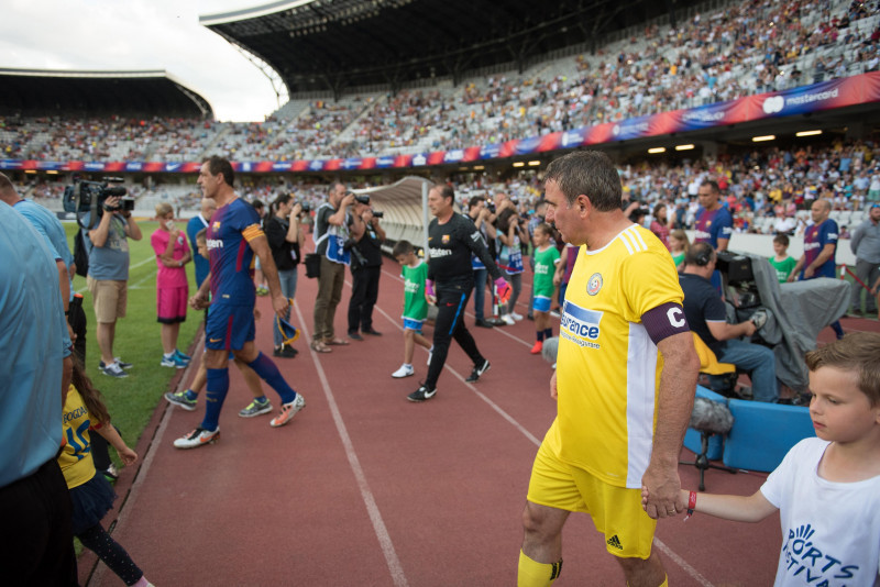 CLUJ, ROMANIA - JUNE 16, 2018: Football player Gheorghe Hagi (Romania Golden Team) and Barcelona Legends entering the playfield at the beginning of a