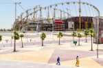 Workers walking past the work of the renovation (roof and cooling) of the Khalifa International Stadium in Doha, Qatar