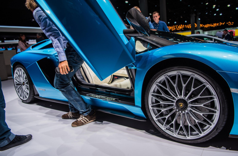 A man gets out of the Lamborghini Aventador S Roadster at the stand of Lamborghini at the International Automobile Fair (IAA) in Frankfurt/Main, Germany, 12 September 2017. The car manufacturers present their newest developments at the world's biggest aut