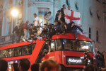 England Fans pictured in Piccadilly and Haymarket jumping on the famous red double-decker bus celebrating after their team reached the Euro's 2020 final beating Denmark 2-1 at Wembley stadium.