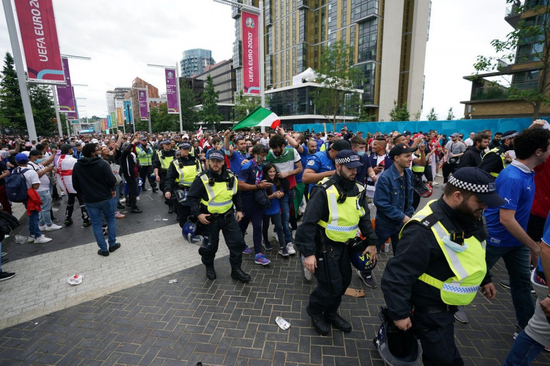 Italy fans are led into the stadium by police ahead of the UEFA Euro 2020 Final at Wembley Stadium, London. Picture date: Sunday July 11, 2021.
