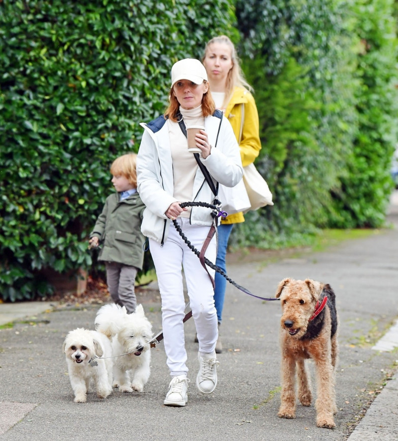 *EXCLUSIVE* Spice Girl Geri Halliwell AKA Ginger Spice pictured rocking an all-white outfit as she's pictured out walking her beloved pet dogs with a friend in North London.