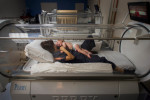 Jesse Arrigo and his mother, Kristin, lie in a hyperbaric chamber