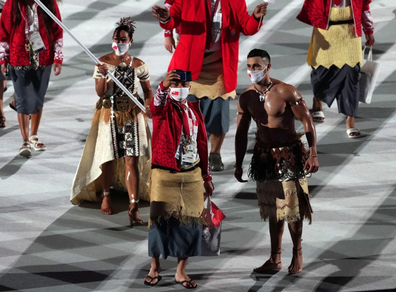 Tonga flagbearers Malia Paseka and Pita Taufatofua lead the team out during the opening ceremony of the Tokyo 2020 Olympic Games at the Olympic Stadium in Japan. Picture date: Friday July 23, 2021.