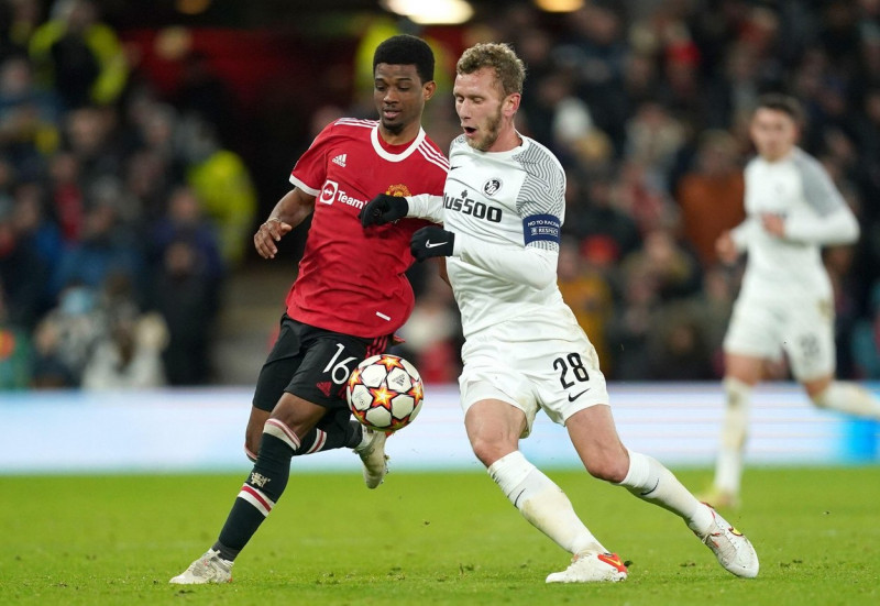 Manchester United's Amad Diallo (left) and Young Boys' Fabian Lustenberger battle for the ball during the UEFA Champions League, Group F match at Old Trafford, Manchester. Picture date: Wednesday December 8, 2021.