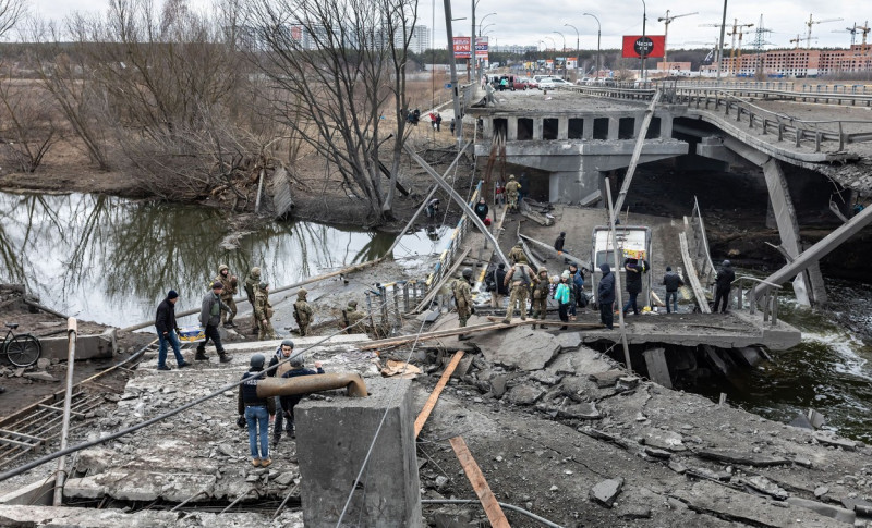People cross destroyed bridge in Irpin, Ukraine - 05 Mar 2022