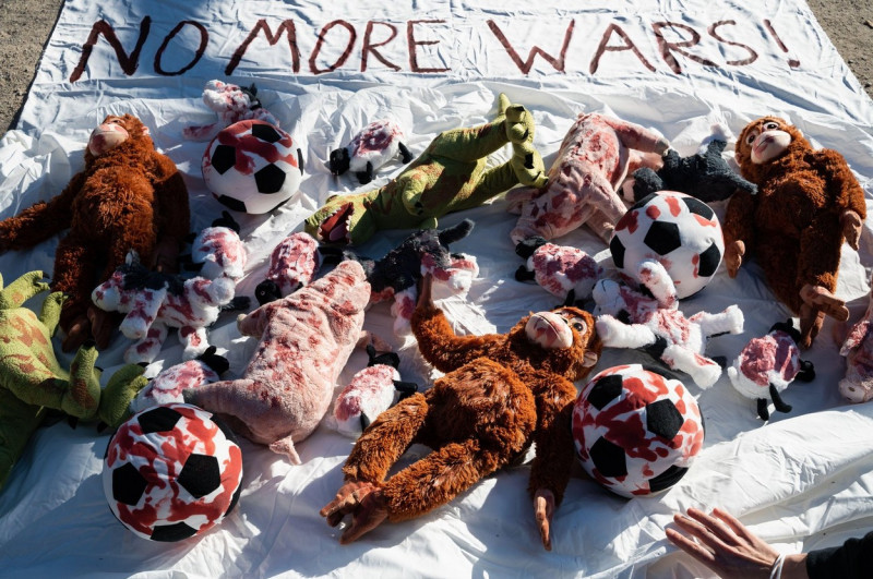 07.03.2022, Berlin, Germany, Europe - Installation with blood-soaked soft toys on a banner as symbolic representation of the number of kids who died.