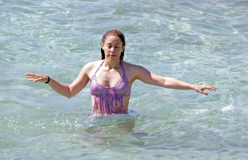 *EXCLUSIVE* WEB MUST CALL FOR PRICING - Columbian superstar singer Shakira shows off her toned beach body in a purple bikini while enjoying some fun time on the beach with her children in Ibiza!