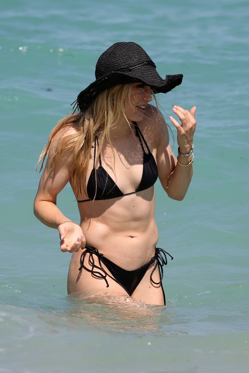 Eugenie "Genie" Bouchard looks gorgeous in a little black bikini and matching sun hat on the beach in Miami