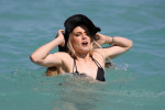 Eugenie "Genie" Bouchard looks gorgeous in a little black bikini and matching sun hat on the beach in Miami