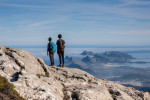 two young people observing the bay of Alcudia from a top, Escorca, Mallorca, Balearic Islands, Spain.
