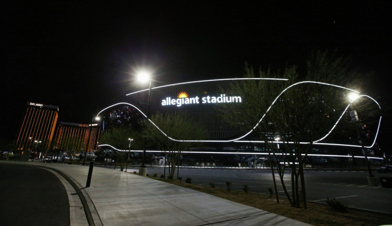 Las Vegas, United States. 18th Mar, 2022. An exterior view of Allegiant Stadium at night with Mandalay Hotel &amp; Casino in the background. Credit: SOPA Images Limited/Alamy Live News
