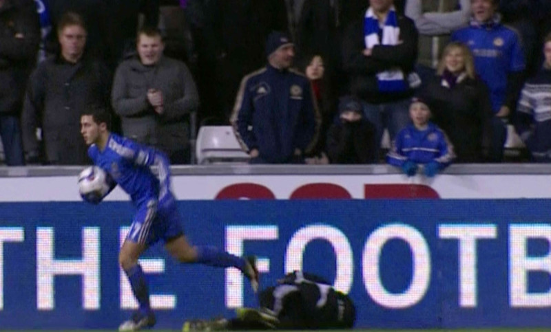 Eden Hazard kicks ball boy Charlie Morgan