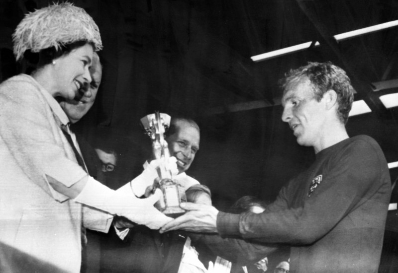 Sport Football General Play International World Cup,Queen presents cup to England's Captain. Britiain's Queen Elizabeth II is pictured presenting the Jules Rimet World Cup Trophy to England's Captain Bobby Moore, after England defeated West Germany in