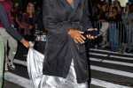 Serena Williams walks into the Vogue fashion show in a platinum dress