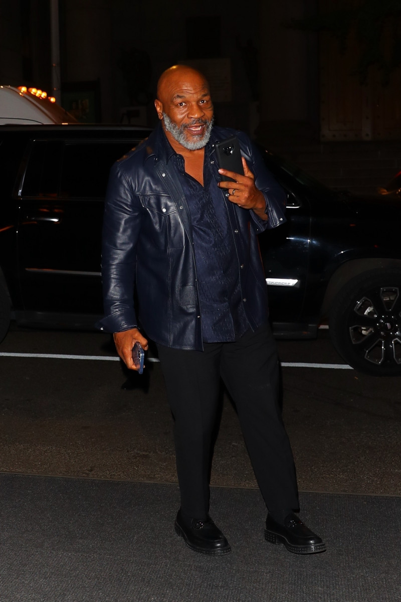 Mike Tyson chats it up on the phone call while arriving back at his downtown hotel in New York
