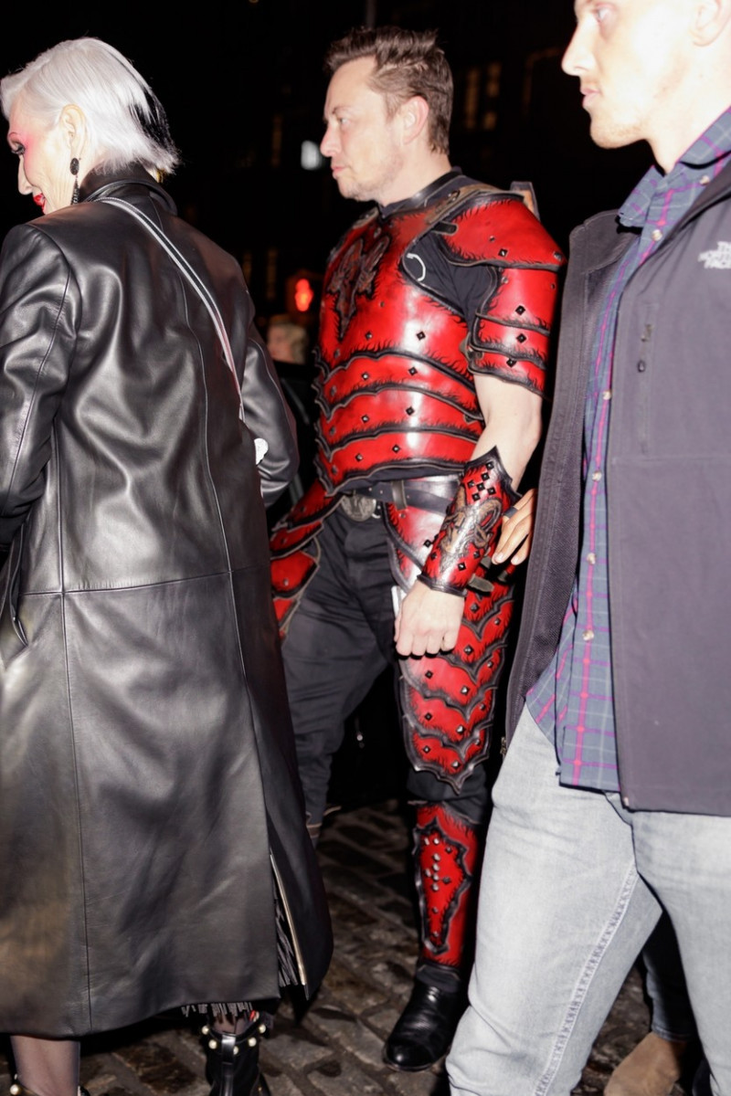 Elon Musk wears a knight costume with an upside-down cross on the back as he arrives at Heidi Klum’s Halloween party in NYC