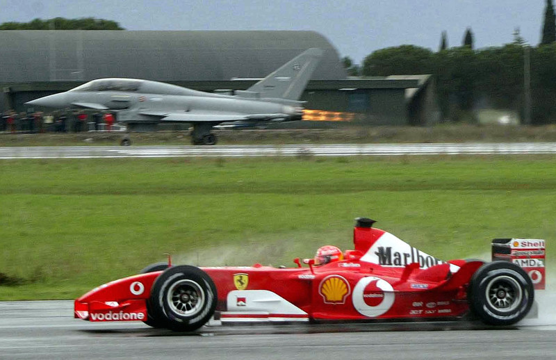 Michael Schumacher Of Ferrari Races Eurofighter Typhoon Aircraft